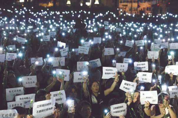 La noche del viernes, cientos de mamás protestaron contra la represión de la que fueron víctimas sus hijos en Hong Kong. Foto: AP y AFP